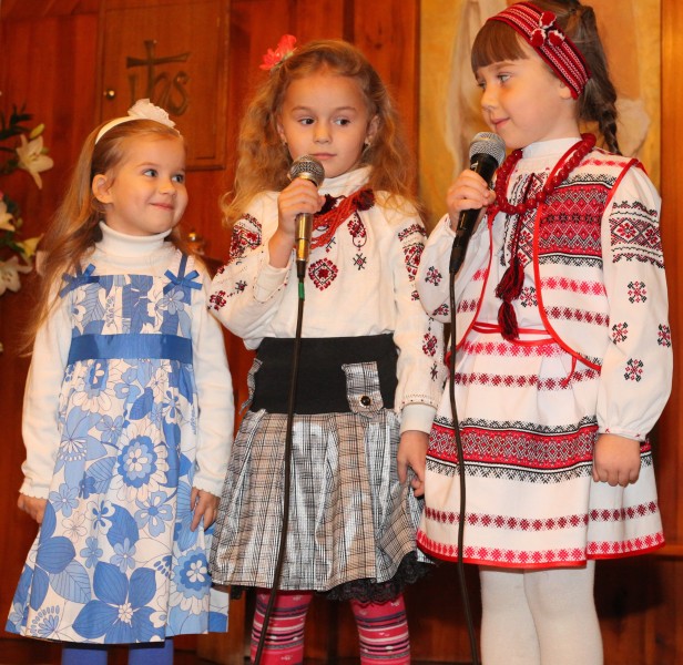 three cute child girls performing in a Church in a Catholic kindergarten, photo 1