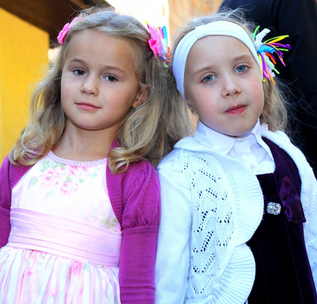 two Catholic child girls near a Church after the Holy Mass