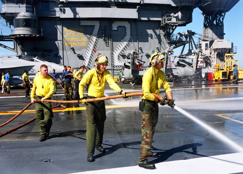 US Navy 030120-N-9403F-002 Sailors spray down sections of USS Abraham Lincoln's non-skid surface