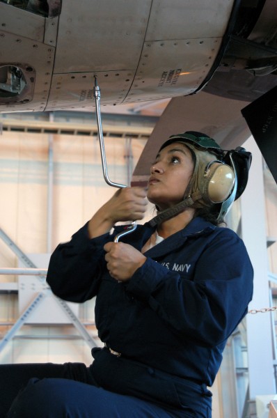 US Navy 030126-N-9760B-004 Aviation Machinist^rsquo,s Mate 2nd Class Roxana Guevara from Irving, Texas, attaches an access panel to the number one engine 