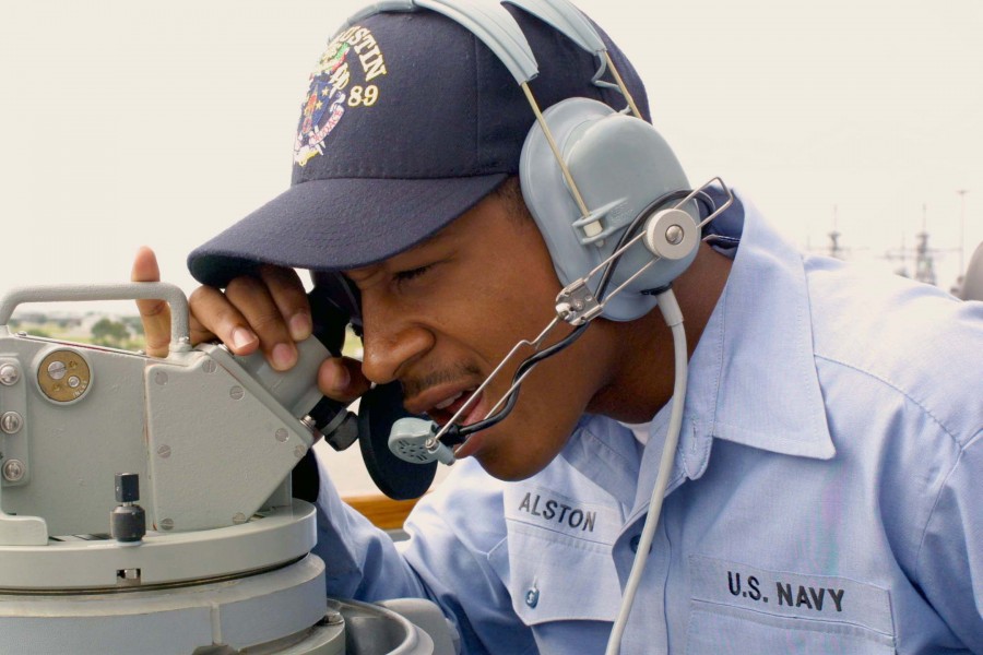 US Navy 030502-N-1350S-010 Operation Specialist Seaman Tyrone S. Alston conducts bearing checks during Sea and Anchor detail as Pre-commissioning Unit (PCU) Mustin (DDG 89) departs Pascagoula, Miss