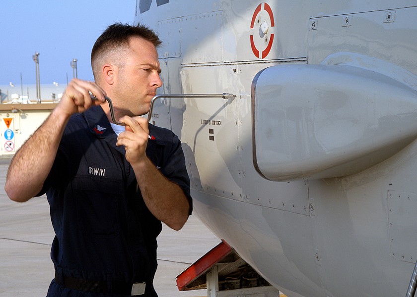 US Navy 040312-N-3770P-001 Aviation Structural Mechanic Equipment 1st Class Daniel Irwin, of Colorado Springs, Colo., opens an access panel to service the liquid oxygen bottles on a C-2A Greyhound