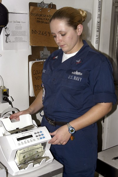 US Navy 040616-N-4973G-031 Disbursing Clerk 2nd Class Danielle King of Newport News, Va., electronically counts money in the disbursing office aboard USS John C. Stennis (CVN 74)