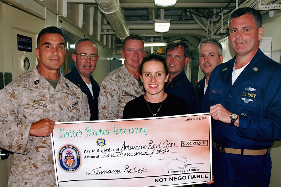 US Navy 050120-N-8668H-045 People display a check representing $10,000 raised by Sailors and Marines during the Blue-Green Tsunami Relief Fund Drive