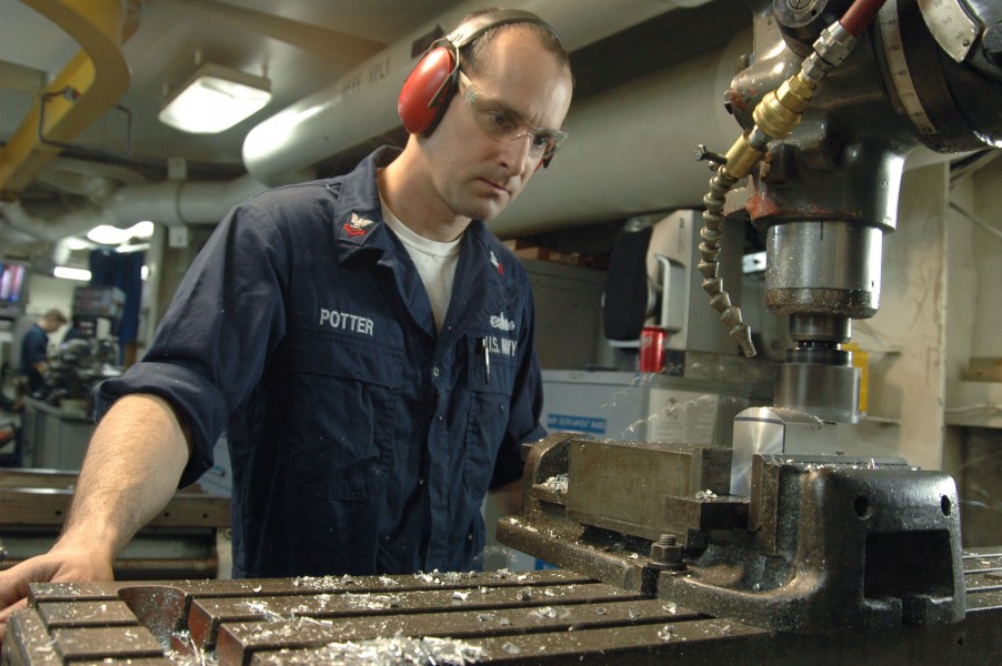US Navy 070228-N-6274T-005 Machinery Repairman 2nd Class David J. Potter uses a milling machine to create a new WSC-8 locking block
