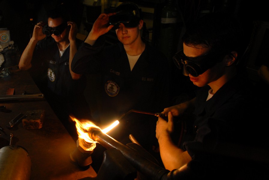 US Navy 070514-N-2659P-165 From left to right, Hull Technician Firemen Noah Rodriguez, Zach Carver and Keir Burnette assist with brazing