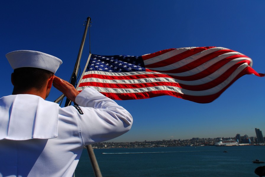 US Navy 070828-N-2659P-007 Aviation Boatswain's Mate (Fuel) Airman Apprentice Moses Perez salutes the national ensign as it is lowered signaling that the Nimitz-class aircraft carrier USS John C. Stennis (CVN 74) is underway