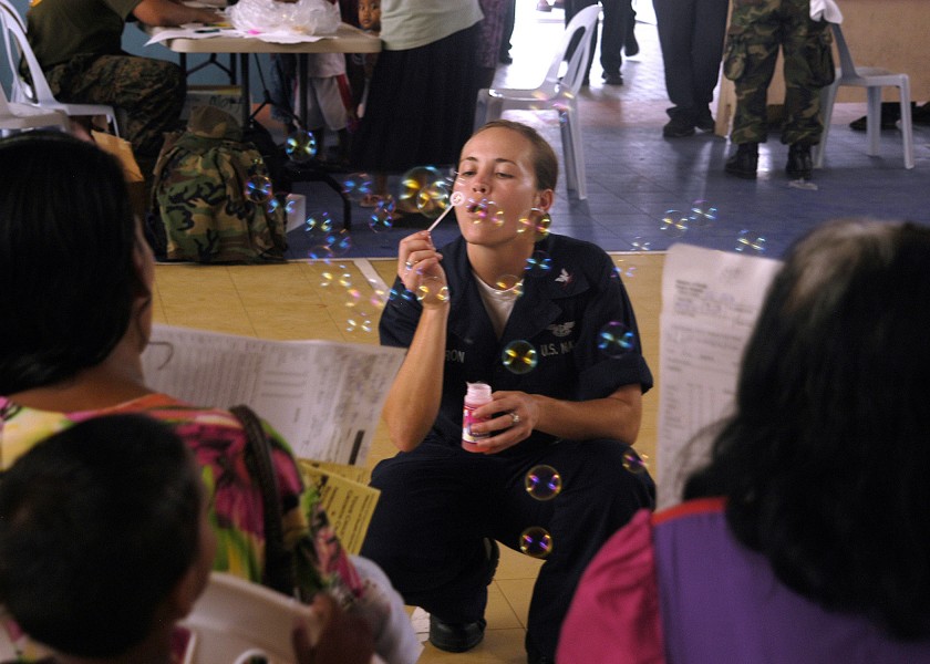 US Navy 070901-N-9195K-040 Aviation Ordnanceman 3rd Class Ashley Cameron blows soap bubbles for local children while assisting with a medical civic action program held at Delap High School