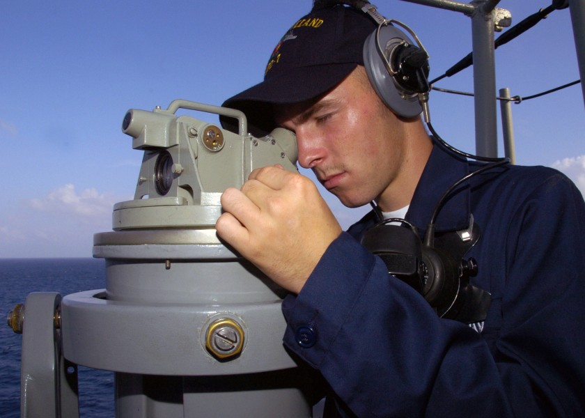 US Navy 071204-N-3925A-001 Seaman Derrick Bryant uses a telescopic alidade to take relative bearing measurements aboard the amphibious transport dock USS Cleveland (LPD 7)