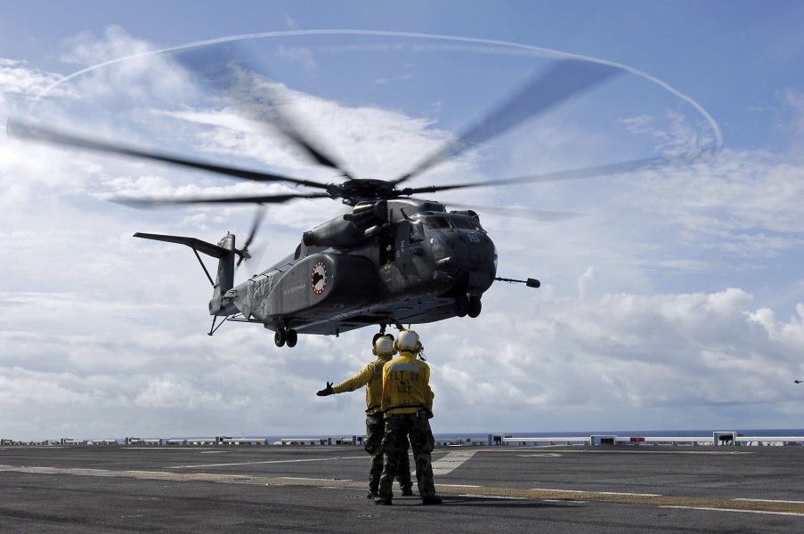 US Navy 080808-N-8335D-078 Aviation Boatswain's Mates (Handling) 3rd Class Jonathan Lambes, left, and Melchor Navora direct an MH-53E Sea Dragon helicopter assigned to Mine Counter Measures Squadron (HM) 15 for a landing on th