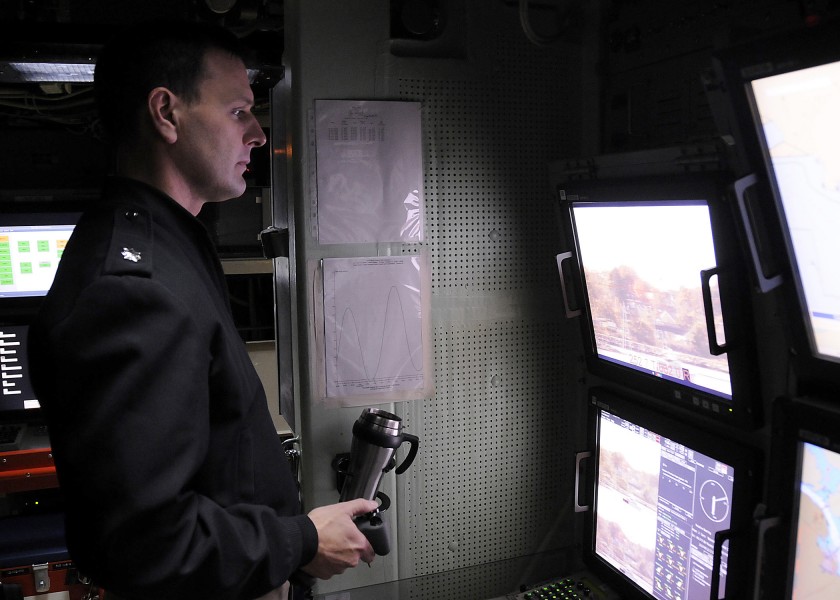 US Navy 081020-N-6553L-007 Cmdr. Mike Stevens, commanding officer of the Virginia-Class fast-attack submarine Pre-commissioning Unit New Hampshire. demonstrates the photonics mast for members of the media