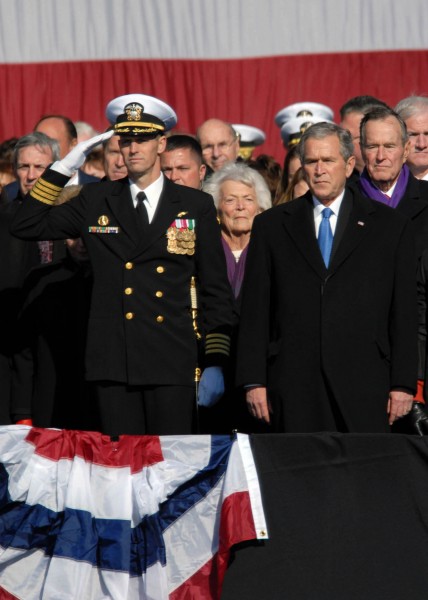 US Navy 090110-N-4408B-156 Capt. Kevin E. O'Flaherty, left, commanding officer of the aircraft carrier USS George H.W. Bush (CVN 77), stands next to President George W. Bush during a 21-gun salute