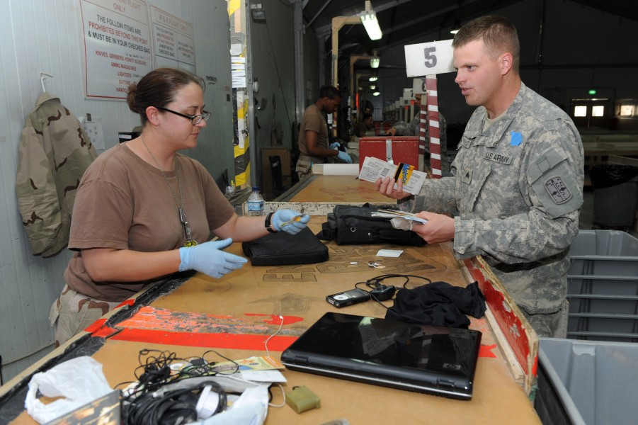 US Navy 090619-N-1452H-128 Aviation Ordnanceman 3rd Class Petty Officer Christina Scandariato from Austin, Texas inspects the contents of a soldier's baggage