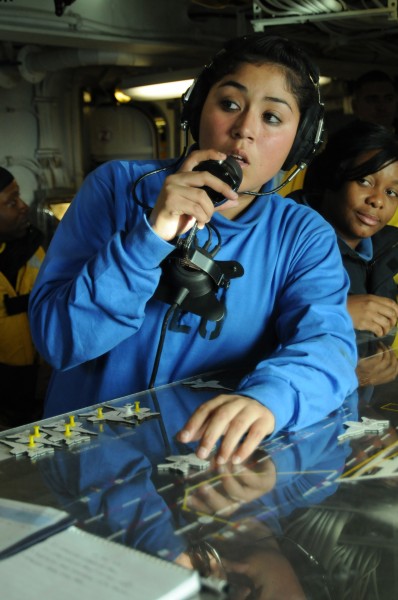 US Navy 091210-N-0808V-031 Aviation Boatswain's Mate (Handling) Airman Jessica Rocha communicates on a sound powered telephone in flight deck control aboard USS Carl Vinson (CVN 70)