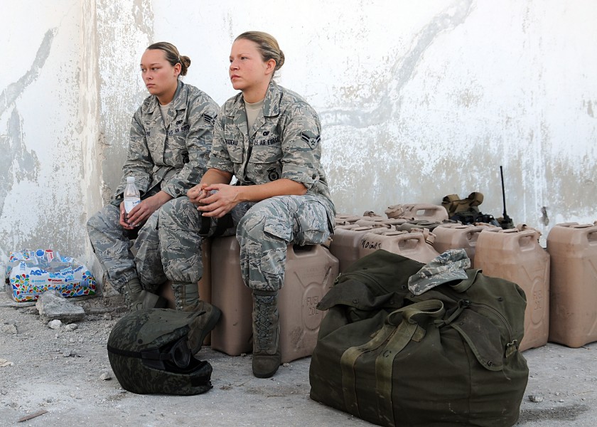 US Navy 100115-N-6247V-103 Senior Airman Lesley Moore, left, of Dayton, Ohio, and Airman 1st Class Stephanie Thibodeau of Milwaukee, Wis., await further orders at the Port-Au-Prince airport