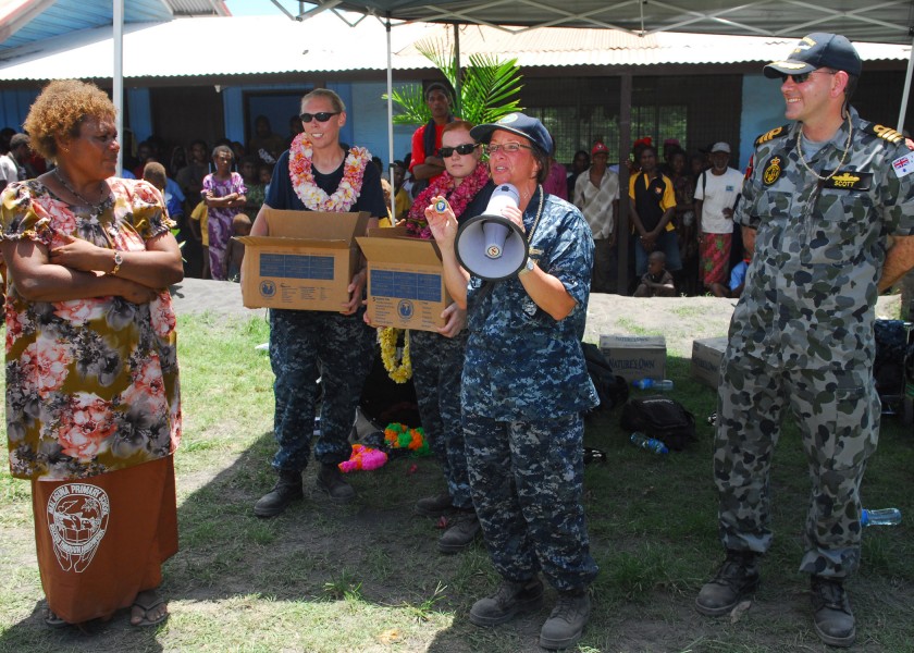 US Navy 100907-N-4044H-320 Capt. Lisa M. Franchetti presents a command coin to Jacobeth Bakut, head teacher of Malaguna Primary School