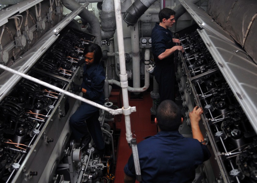 US Navy 110302-N-DM338-102 Sailors open the cylinder head covers on the aft emergency diesel generators in preparation for daily maintenance