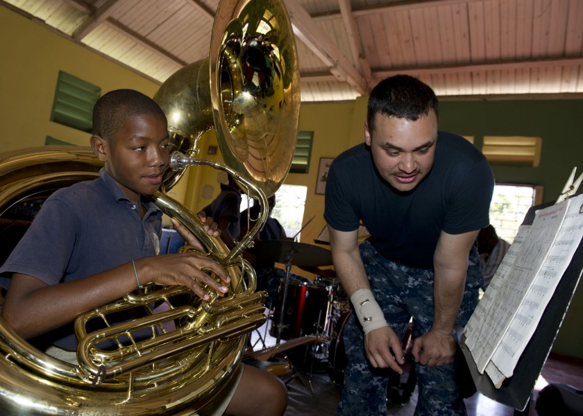 US Navy 110420-N-RM525-032 Musician 3rd Class Christopher Roland, from Atlus, Okla., gives a music lesson to a student