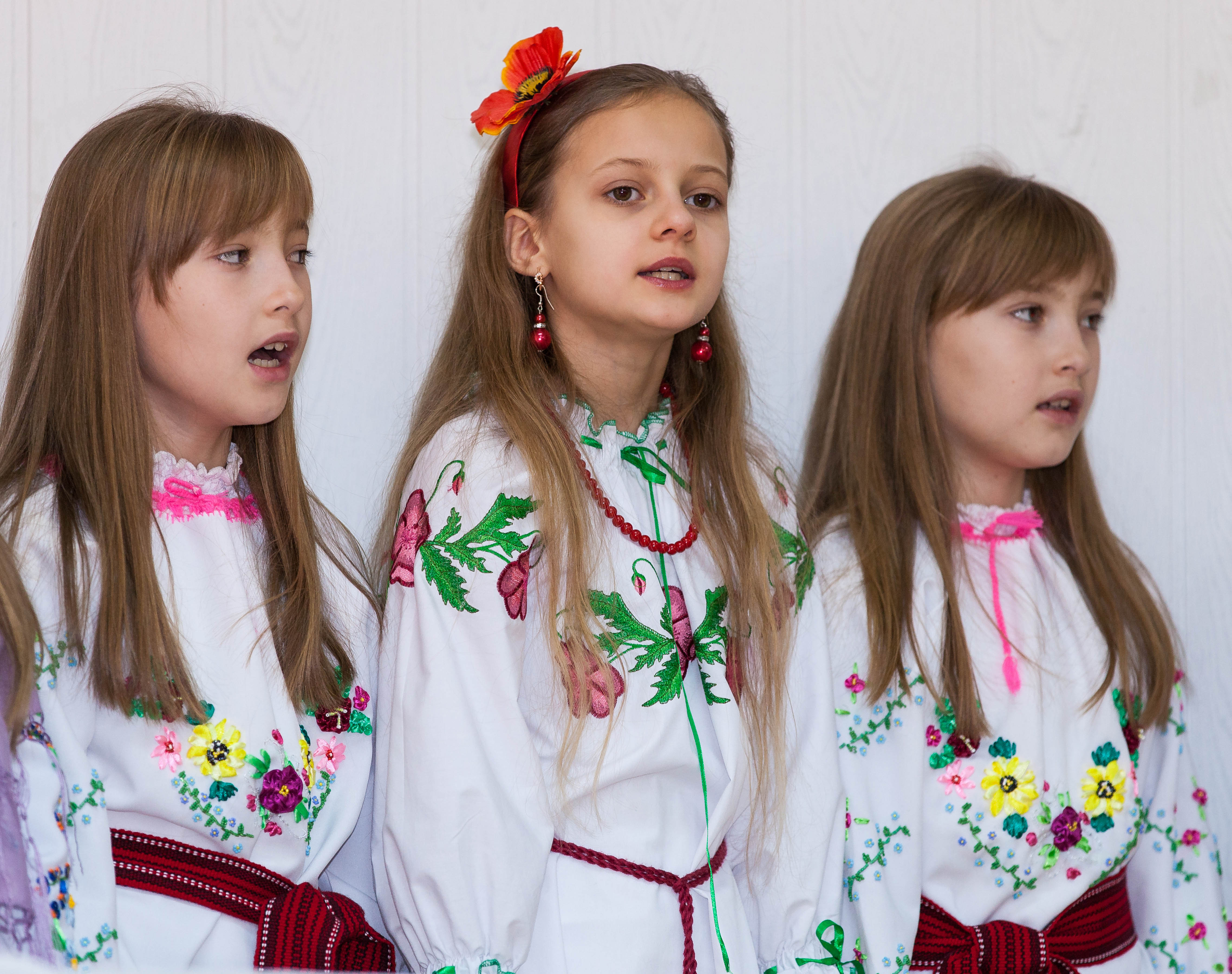 three young schoolgirls performing in December 2013