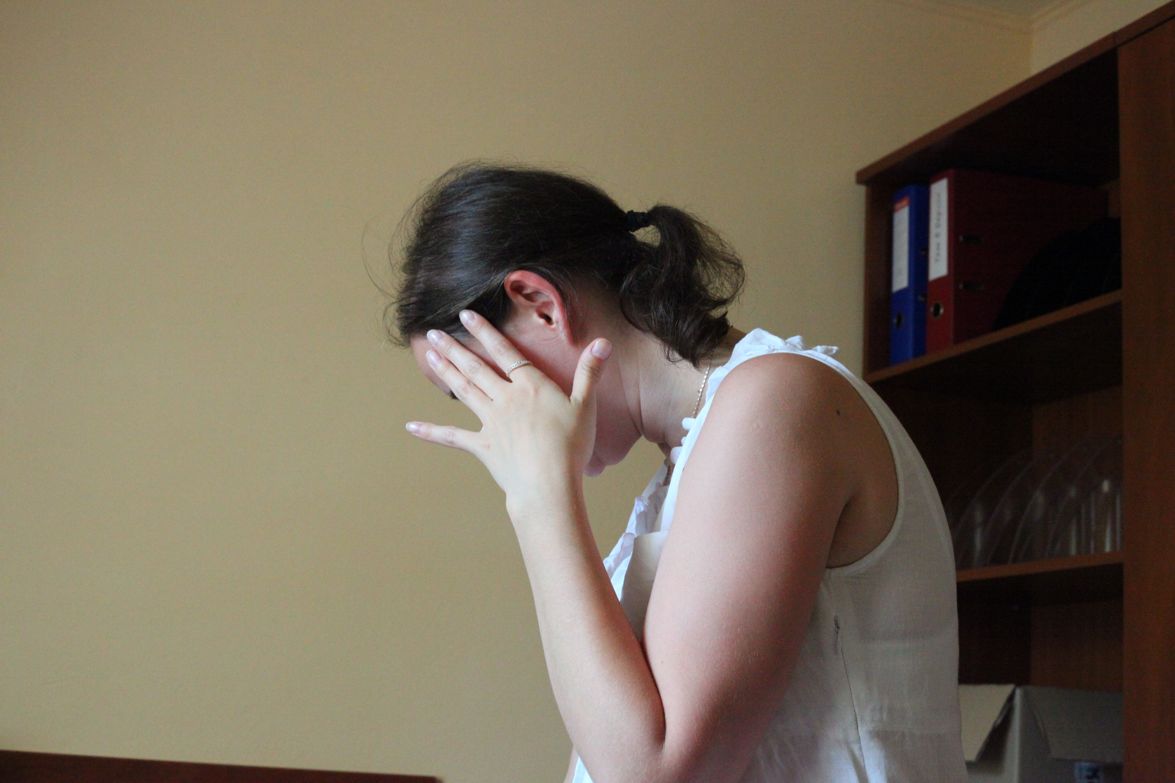 a beautiful Catholic girl hiding from camera, photo 1