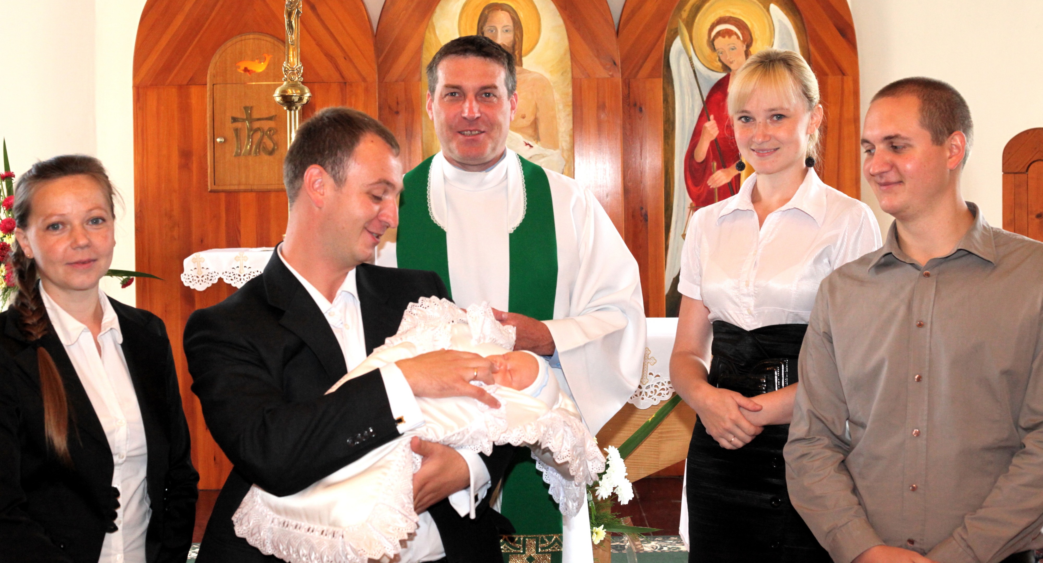 godparents, parents and the priest after the baptism of a baby boy in the Catholic Church, photo 21