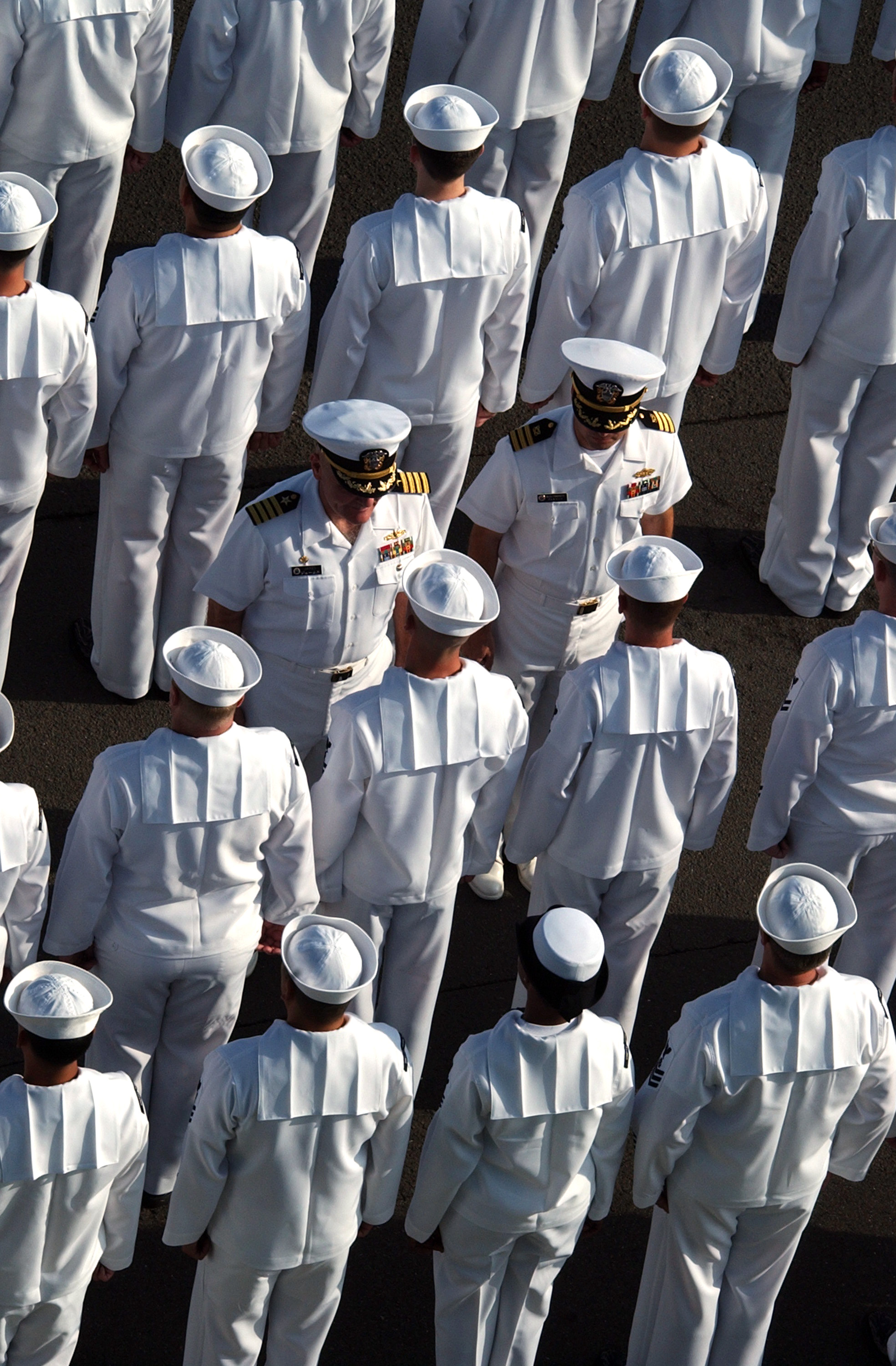 US Navy 040514-N-2420K-002 Sailors assigned to Fleet Activities Sasebo, Japan, stand ready to be inspected by Capt. Michael James