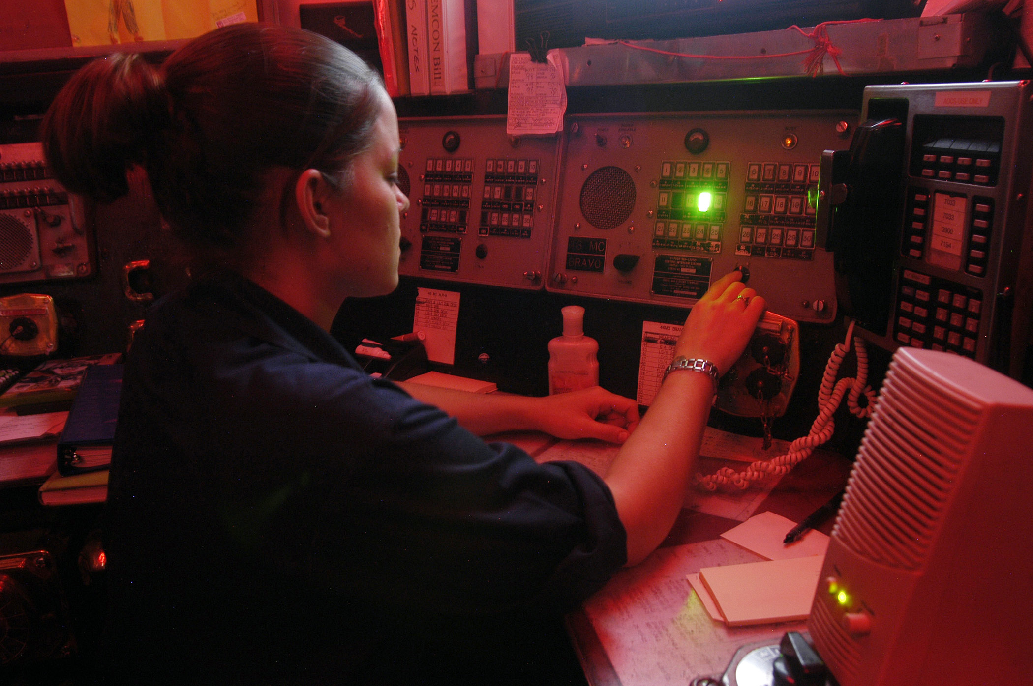 US Navy 040723-N-4565G-002 Aviation Ordnanceman 3rd Class Sara Krueger of Rhintoants, Wis., uses the 46MC to call up the magazine room, during a vertical replenishment with fast combat support ship USS Seattle (AOE 3)