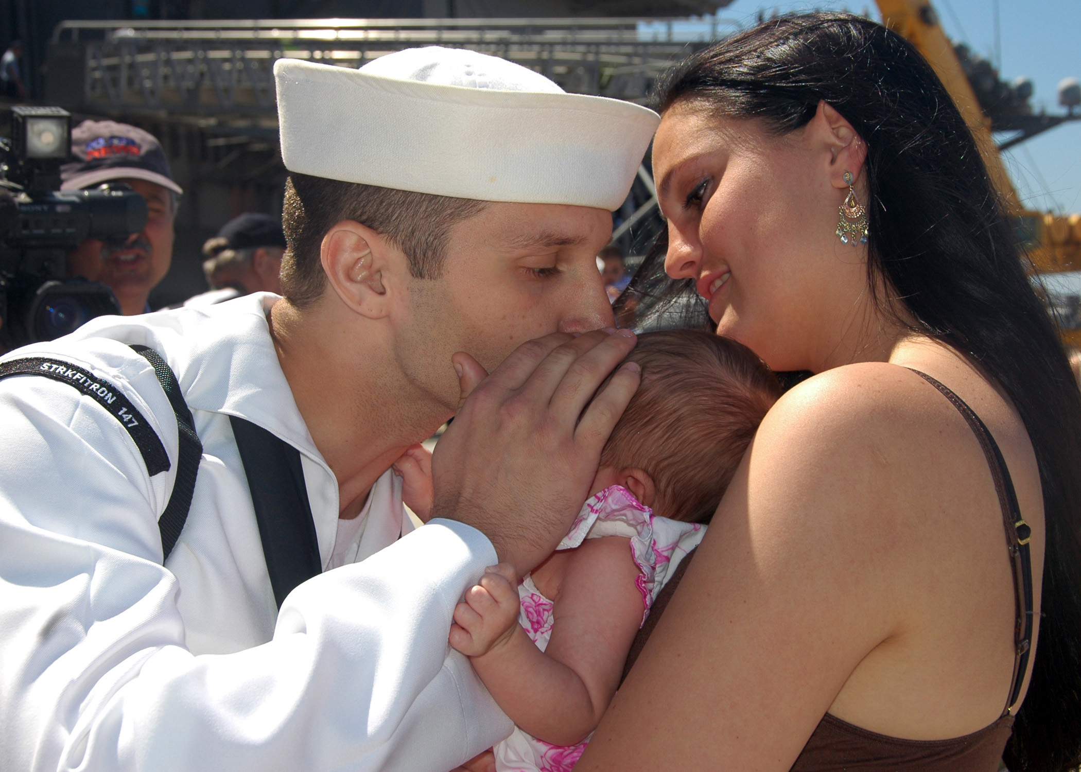 US Navy 070827-N-4007G-004 A Sailor greets his newborn child for the first time at Naval Air Station North Island after concluding a 7.5-month deployment aboard USS John C. Stennis (CVN 74)