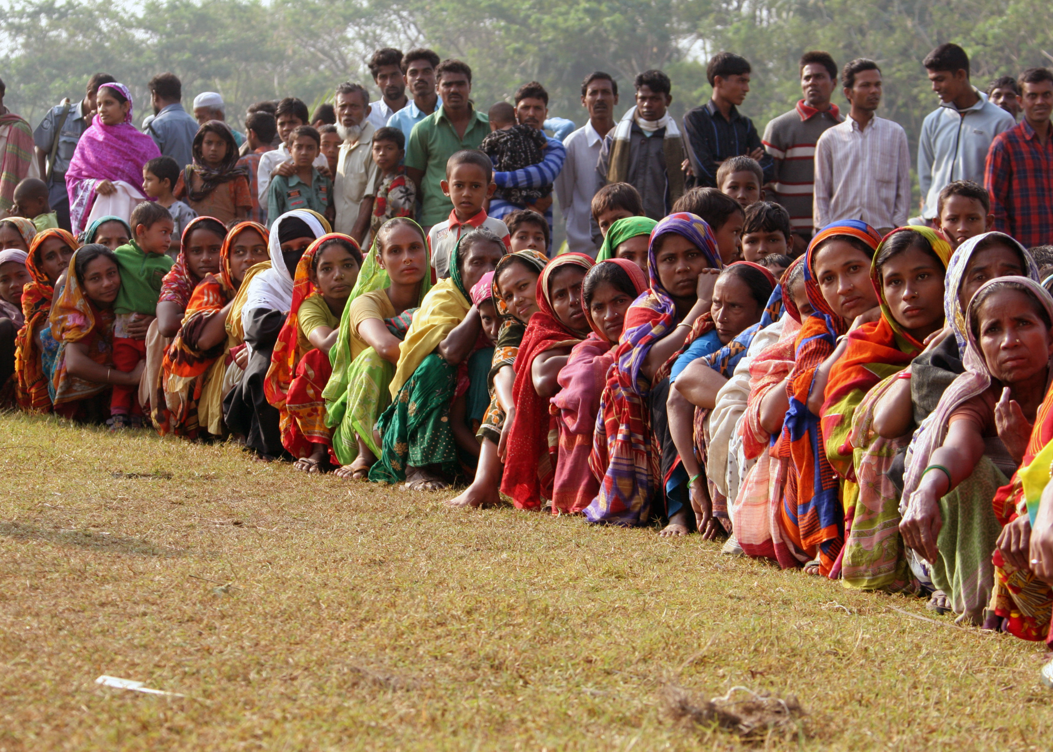 US Navy 071129-M-3095K-009 People gather on a field at Rangabali College in southern Bangladesh to receive medical attention from a U.S. Navy medical team in the wake of Tropical Cyclone Sidr