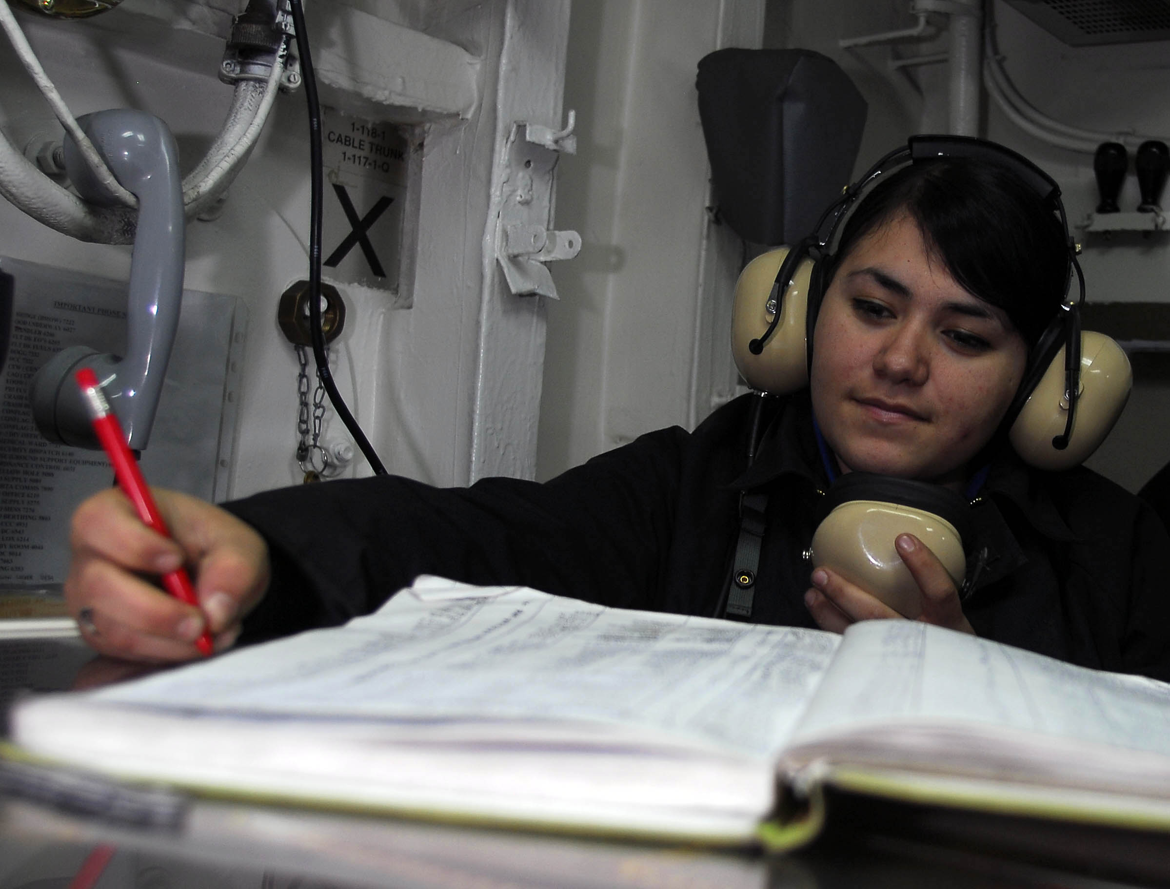 US Navy 081024-N-2717A-021 Aviation Boatswain's Mate (Handling) Airman Sarah Martinez logs the position of aircraft in hangar deck control