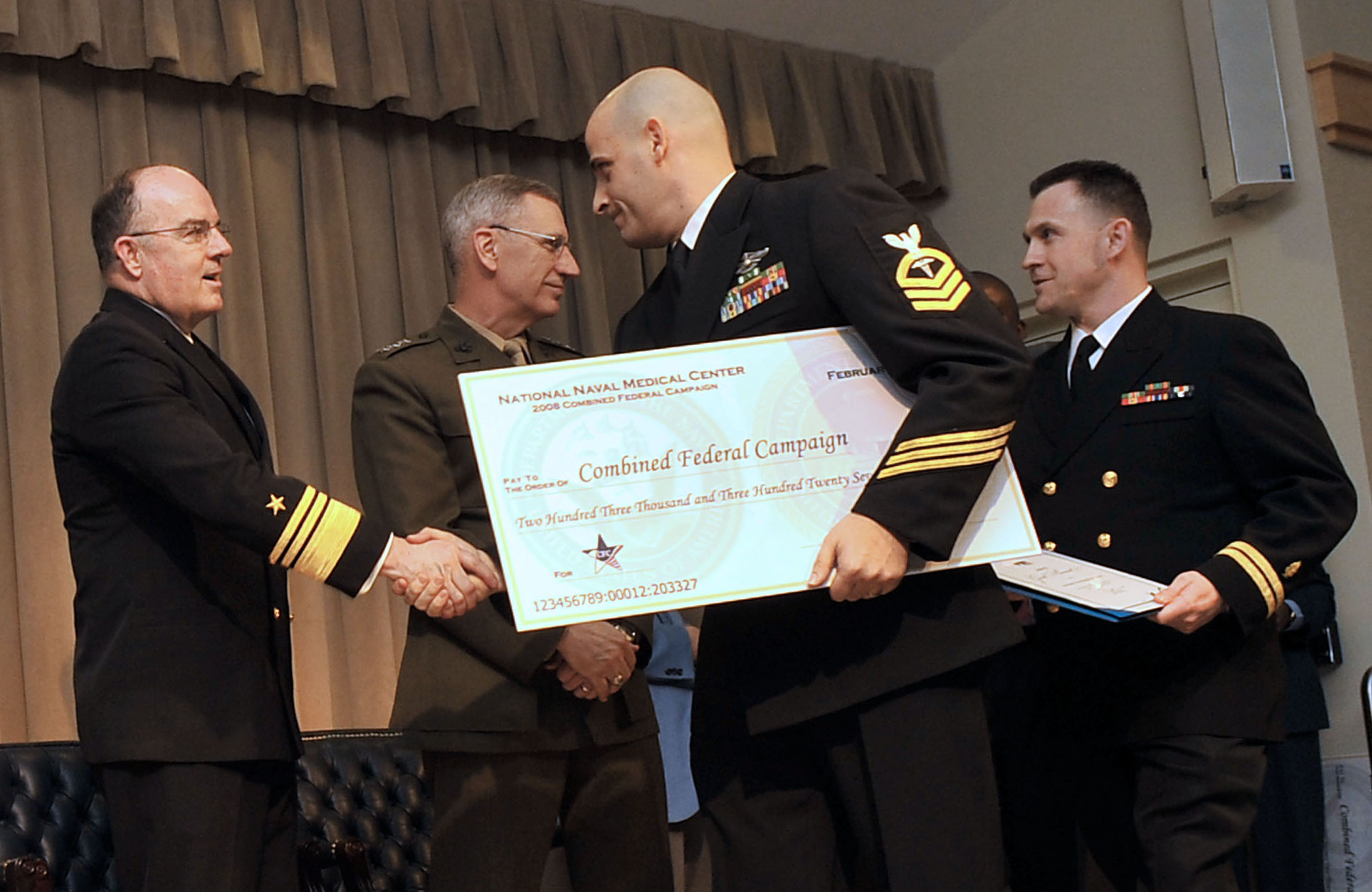 US Navy 090212-N-8273J-025 Vice Adm. John Harvey, Director of Navy Staff, congratulates Chief Hospital Corpsman Daniel Rossi for the contributions from the National Naval Medical Center