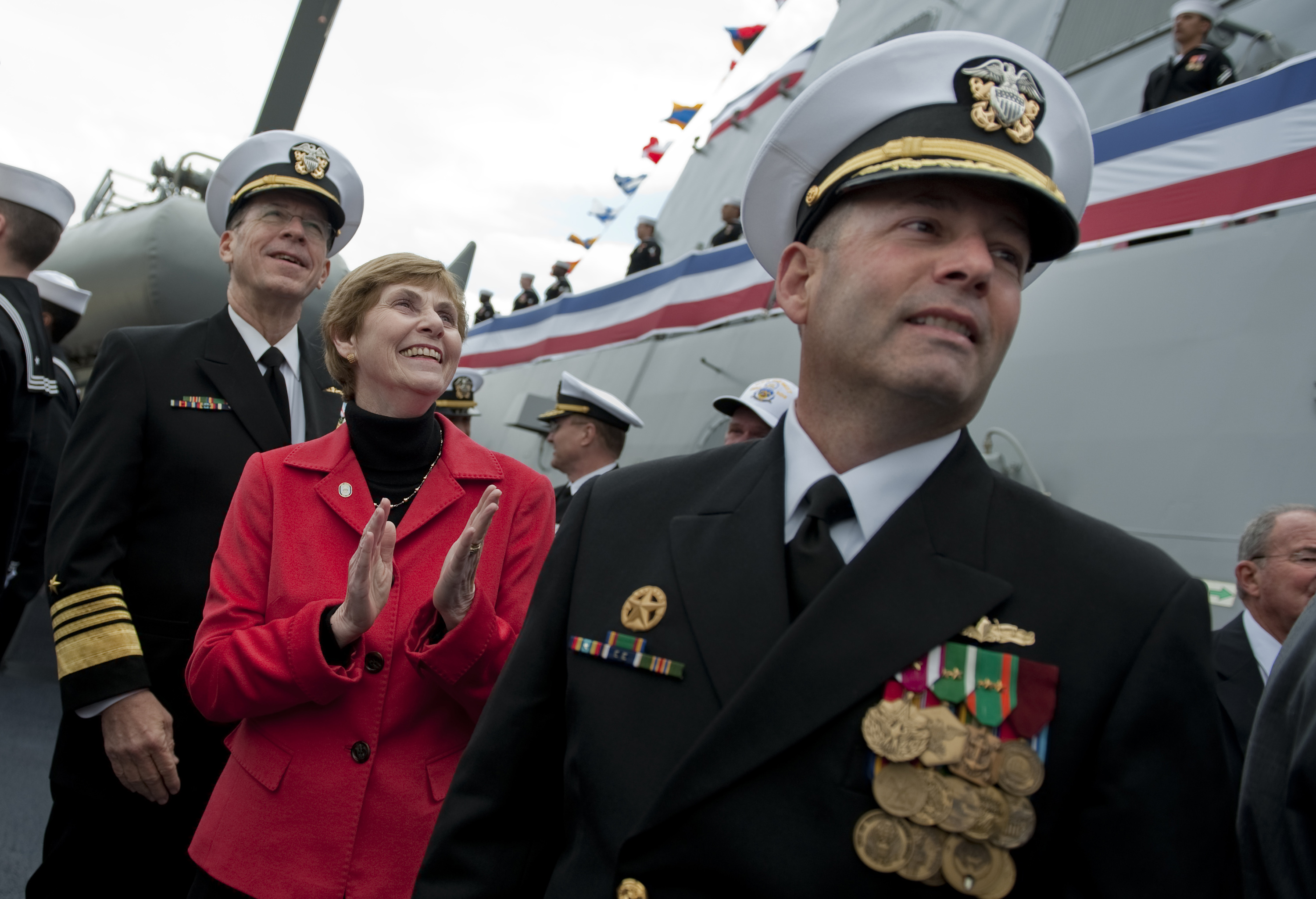 US Navy 100306-N-0696M-131 Chairman of the Joint Chiefs of Staff Adm. Mike Mullen, his wife, Deborah Mullen, and Cmdr. Warren R. Buller watch the crew bring Dewey to life during the ship's commissioning ceremony