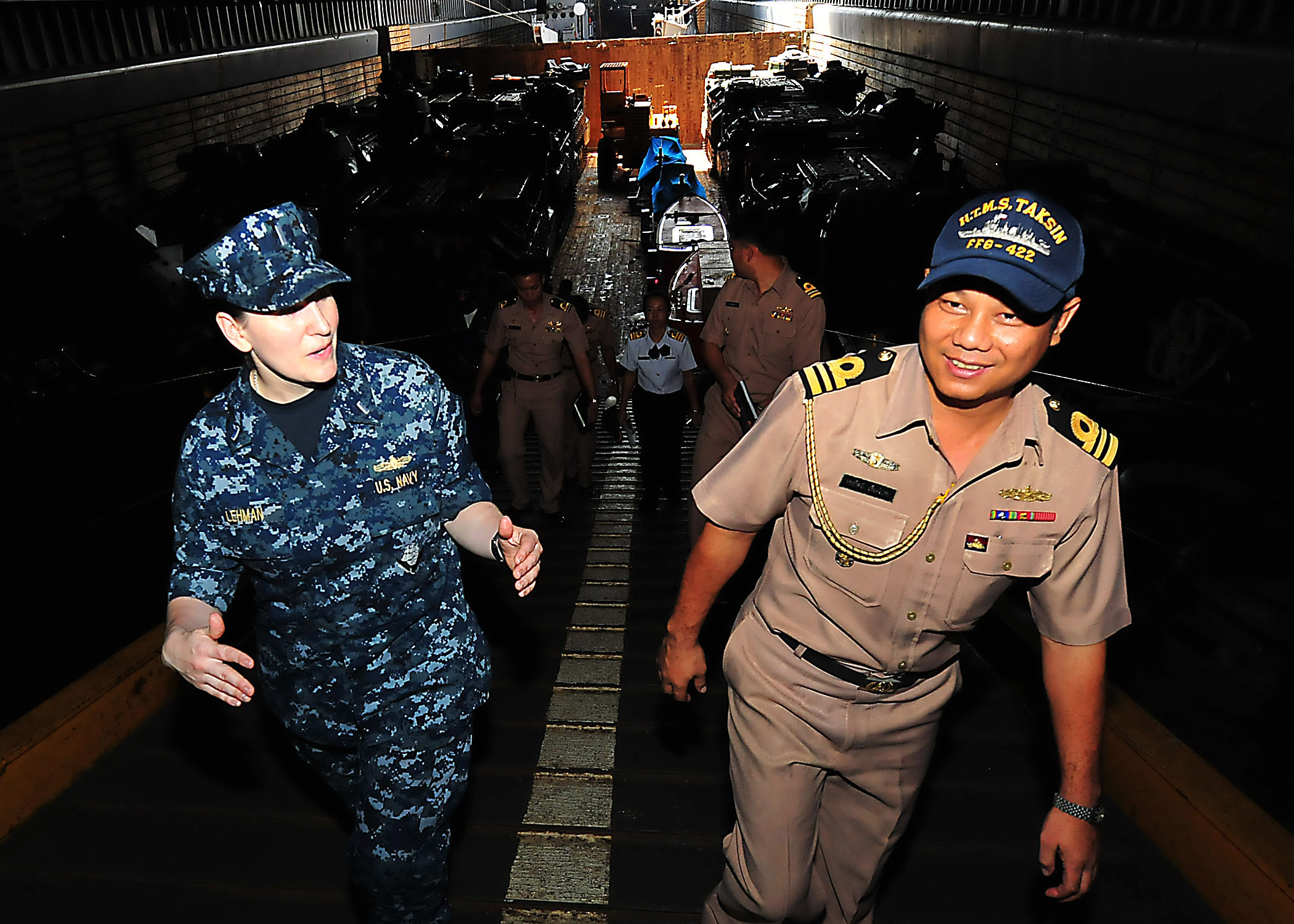 US Navy 100511-N-7643B-113 Lt. j.g. Theresa Lehman explains well deck operations aboard the amphibious dock landing ship USS Tortuga (LSD 46) to a Royal Thailand Navy officer