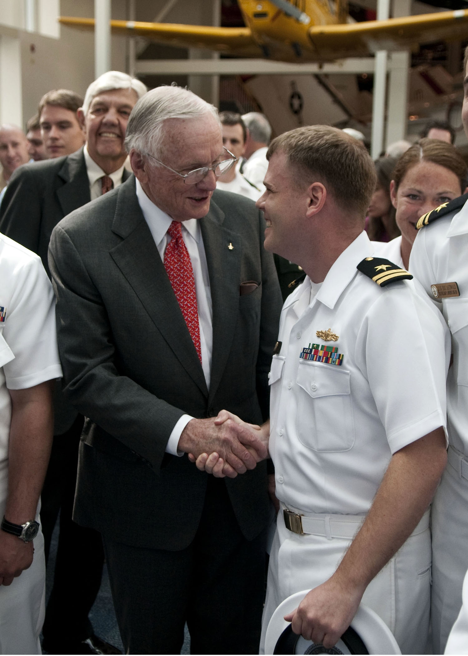 US Navy 100514-N-3852A-004 Former astronaut Neil Armstrong is congratulated by Lt. Gavin Clough, from San Diego, Calif. after Armstrong's induction to the Naval Aviation Hall of Honor in Pensacola, Fla