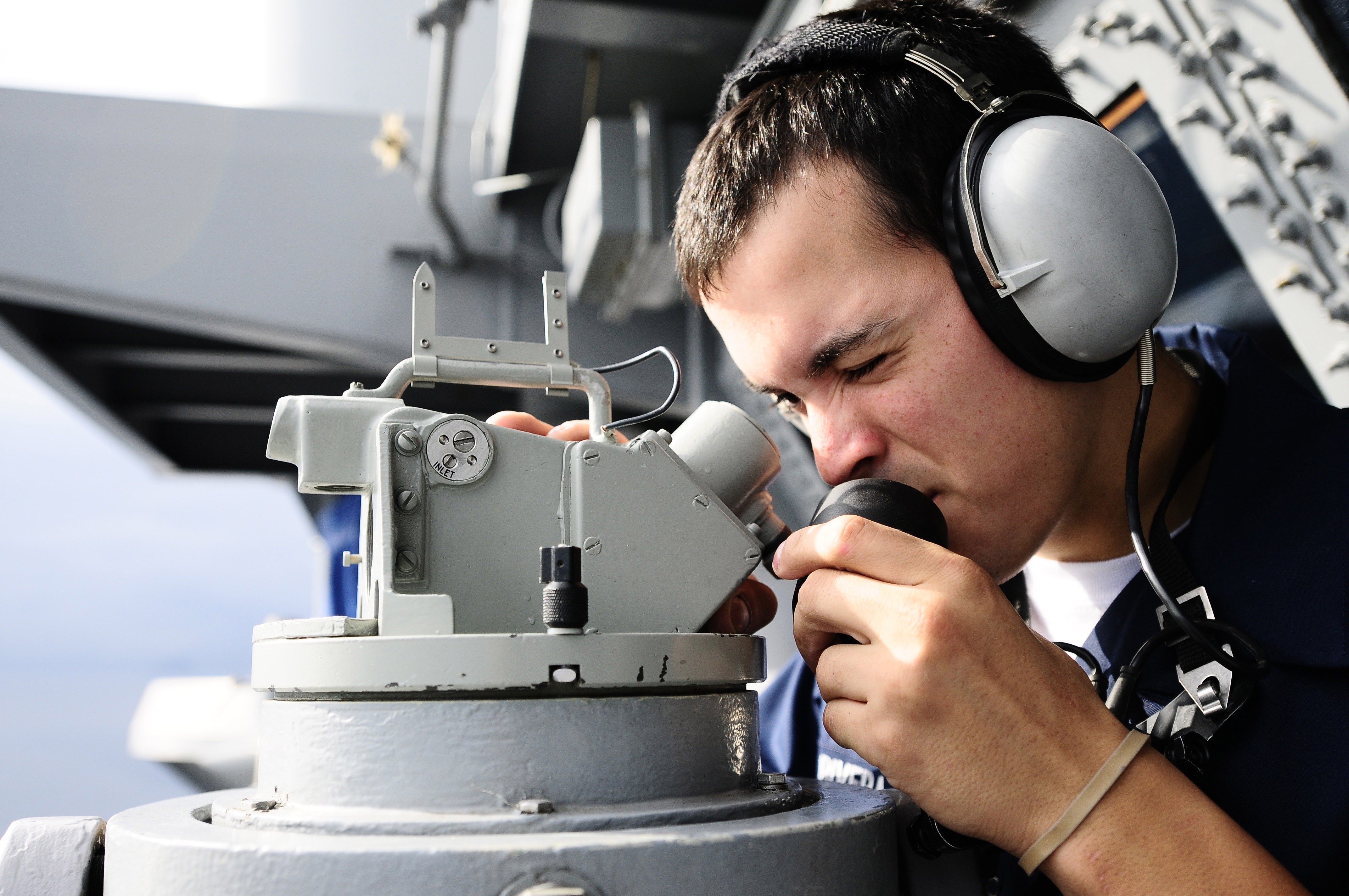 US Navy 101019-N-8040H-091 Quartermaster Seaman Apprentice Matthew Rivera shoots bearings aboard the aircraft carrier USS Carl Vinson (CVN 70)