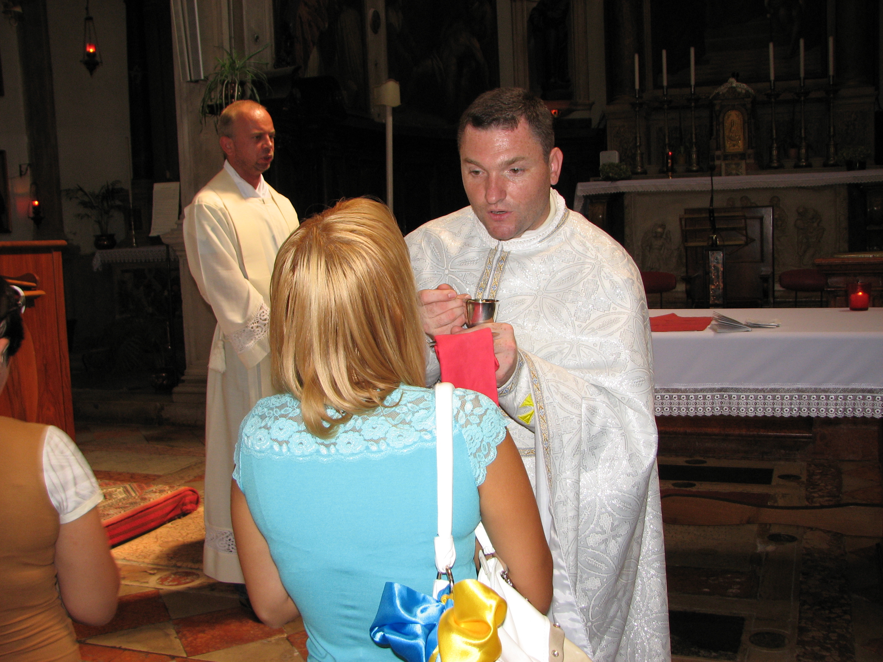 A young woman taking Jesus in the Holy Communion in Venice, Italy, European Union, August 2011, picture 16