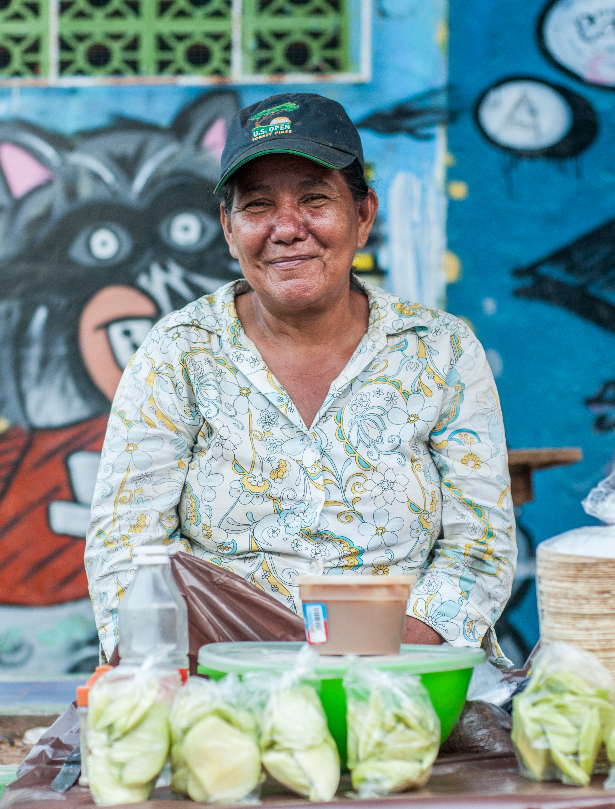 Woman selling green mangoes