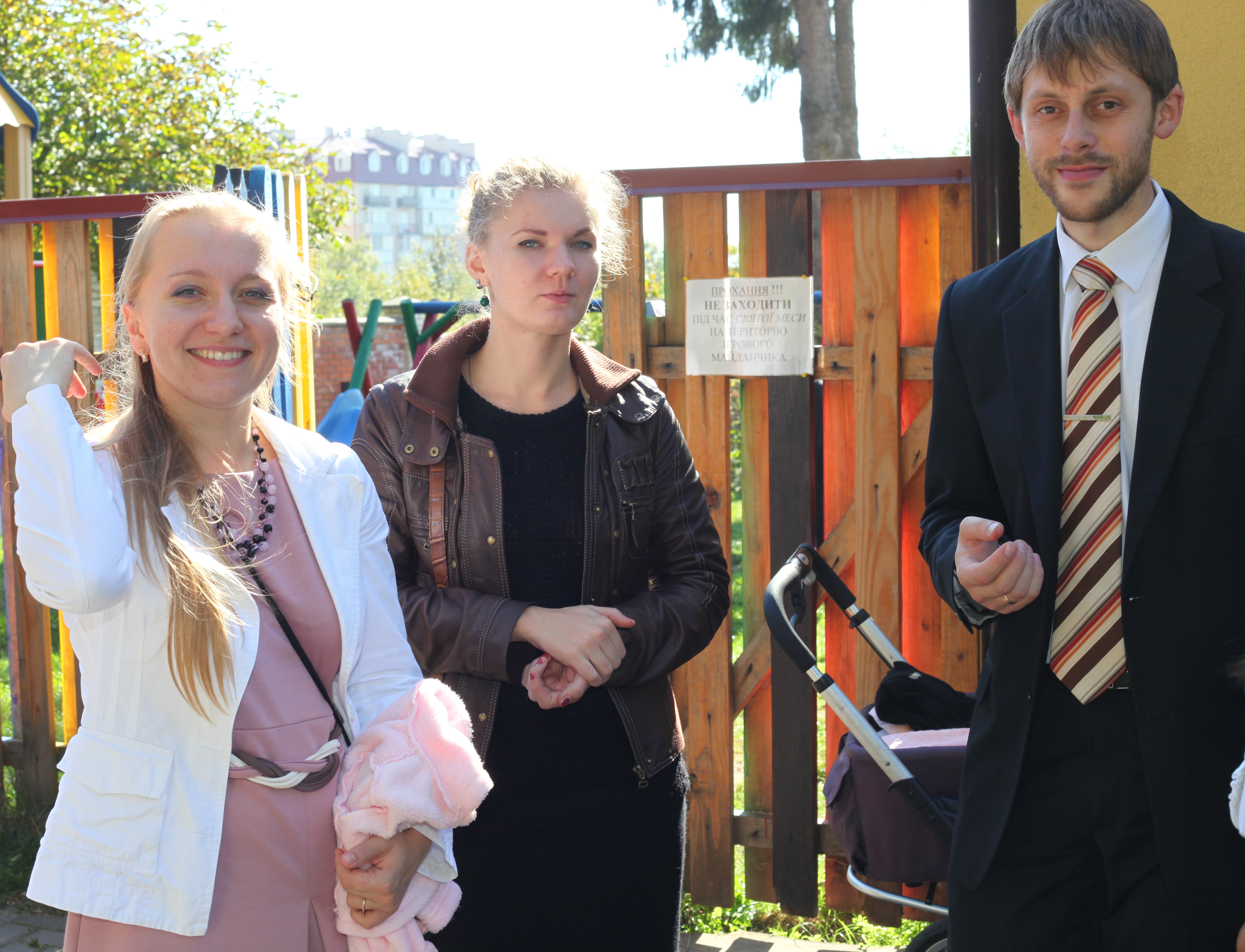 young Catholic people near a Church after the Holy Mass