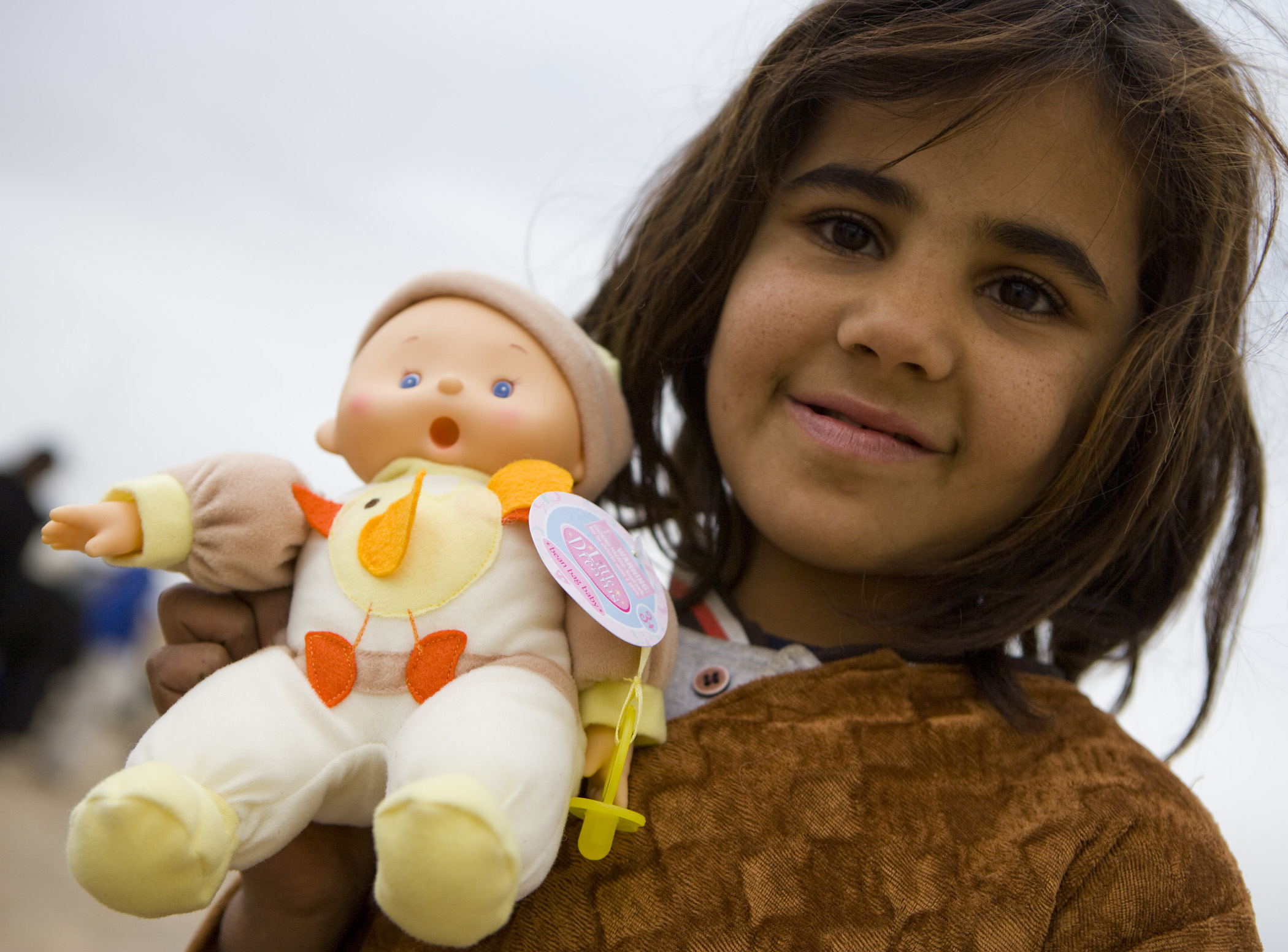 Happy Afghan girl after been given a doll