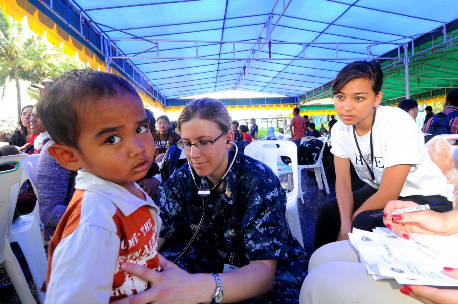 Defense.gov News Photo 100727-A-5573A-359 - U.S. Navy Lt. Stacy Dodt a doctor embarked aboard the Military Sealift Command hospital ship USNS Mercy T-AH 19 examines an Indonesian child