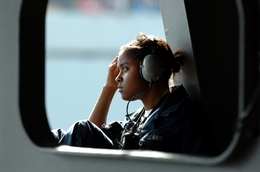 US Navy 060525-N-0555B-059 Seaman Christina Joiner stands watch observing the transfer of cargo, supplies and food