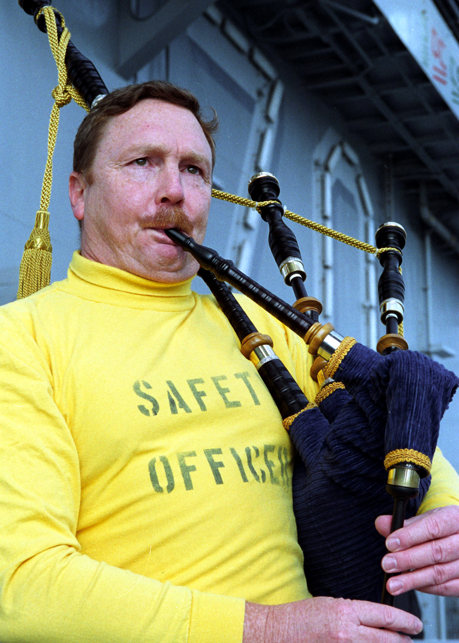 US Navy 021024-N-5555F-004 Cmdr. Jeffrey Wolf plays the bagpipes