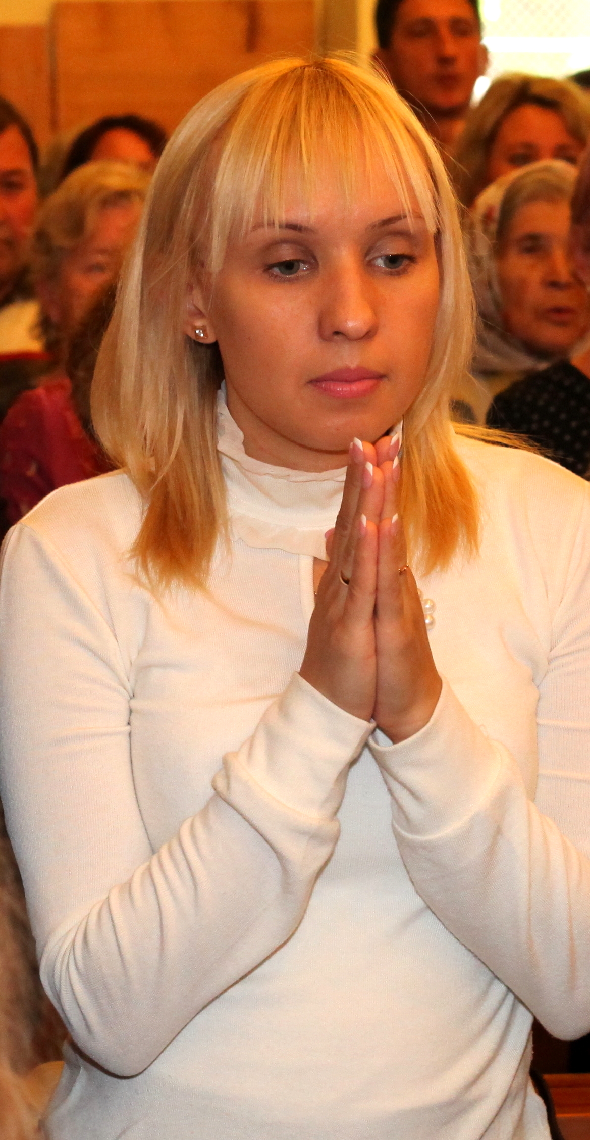 a young Catholic woman praying in a Church, photo 1