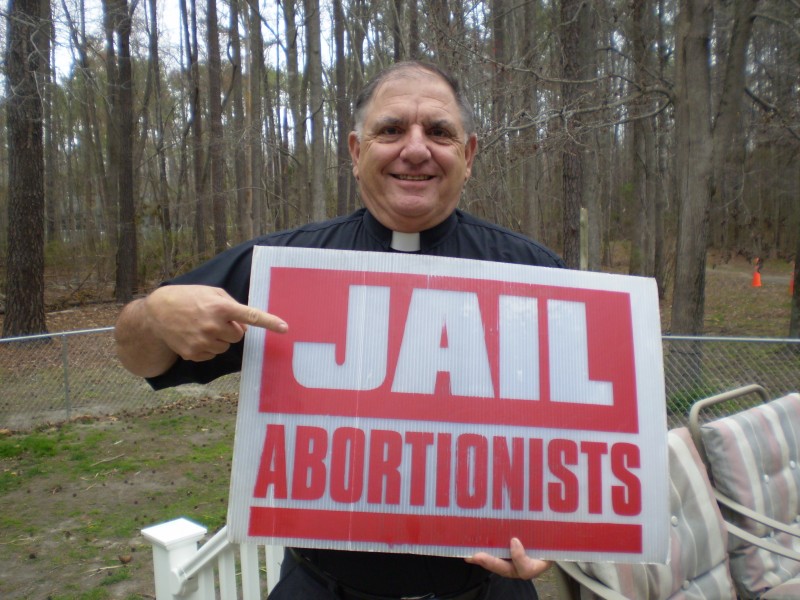Donald Spitz holds anti-abortion sign