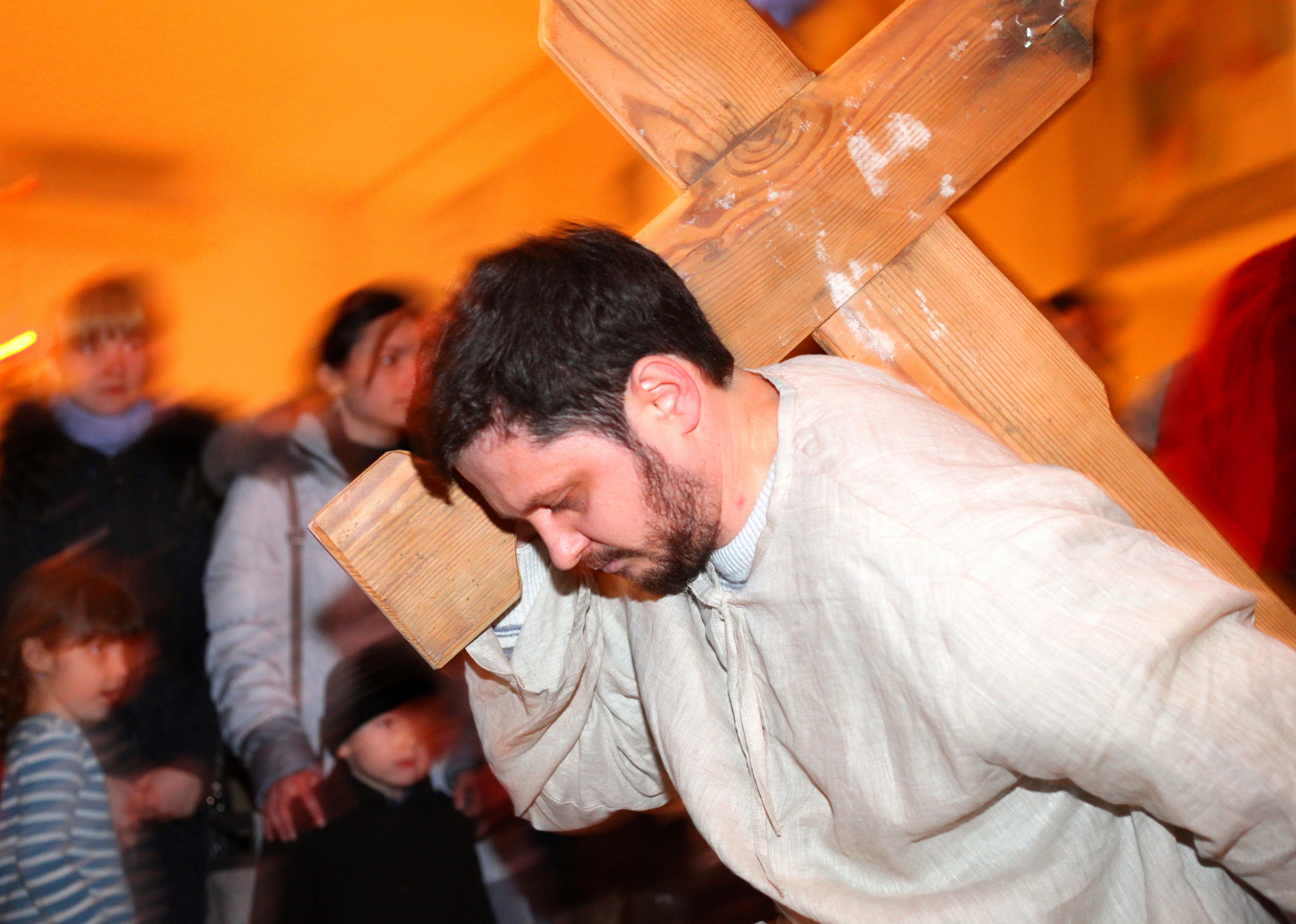 a man performing Jesus carring the cross