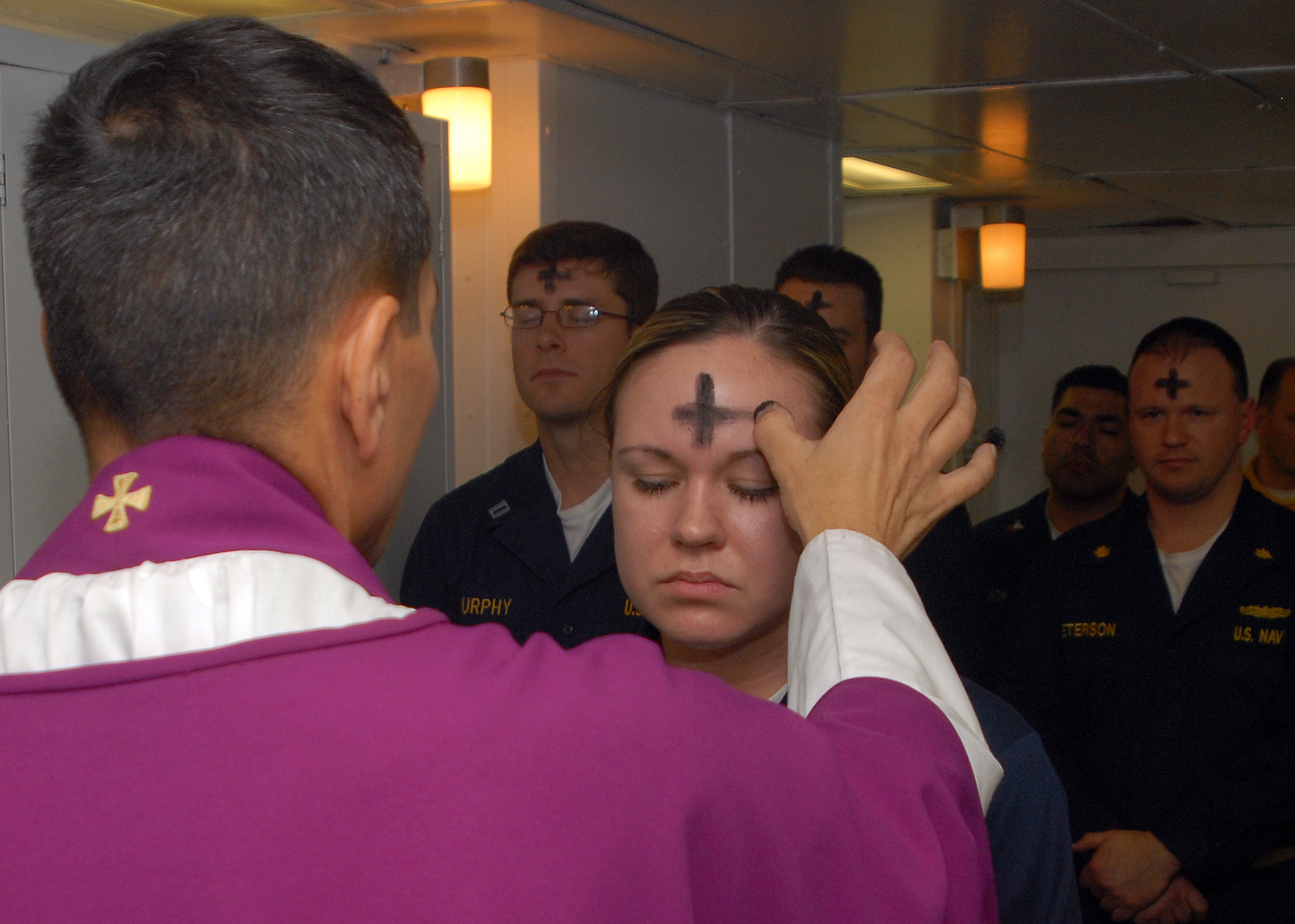 US Navy 080206-N-7869M-057 Electronics Technician 3rd Class Leila Tardieu receives the sacramental ashes during an Ash Wednesday celebration