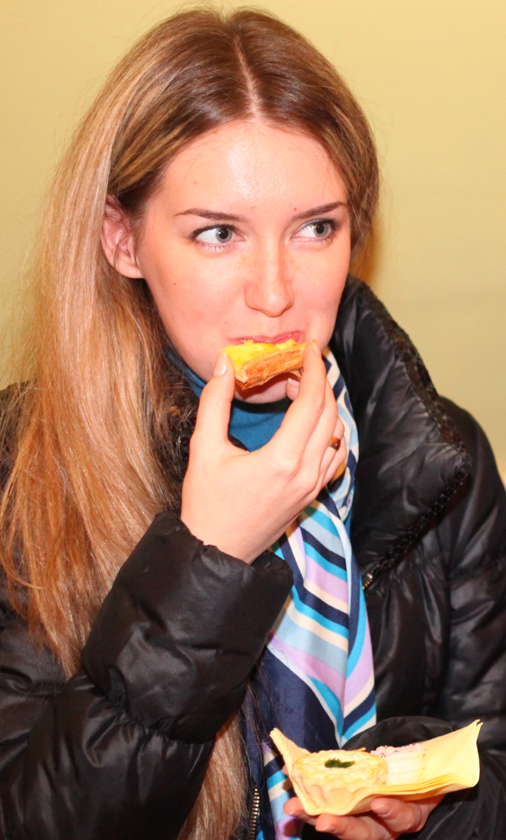 a charming beautiful young fair-haired long-haired woman eating something, photo 7