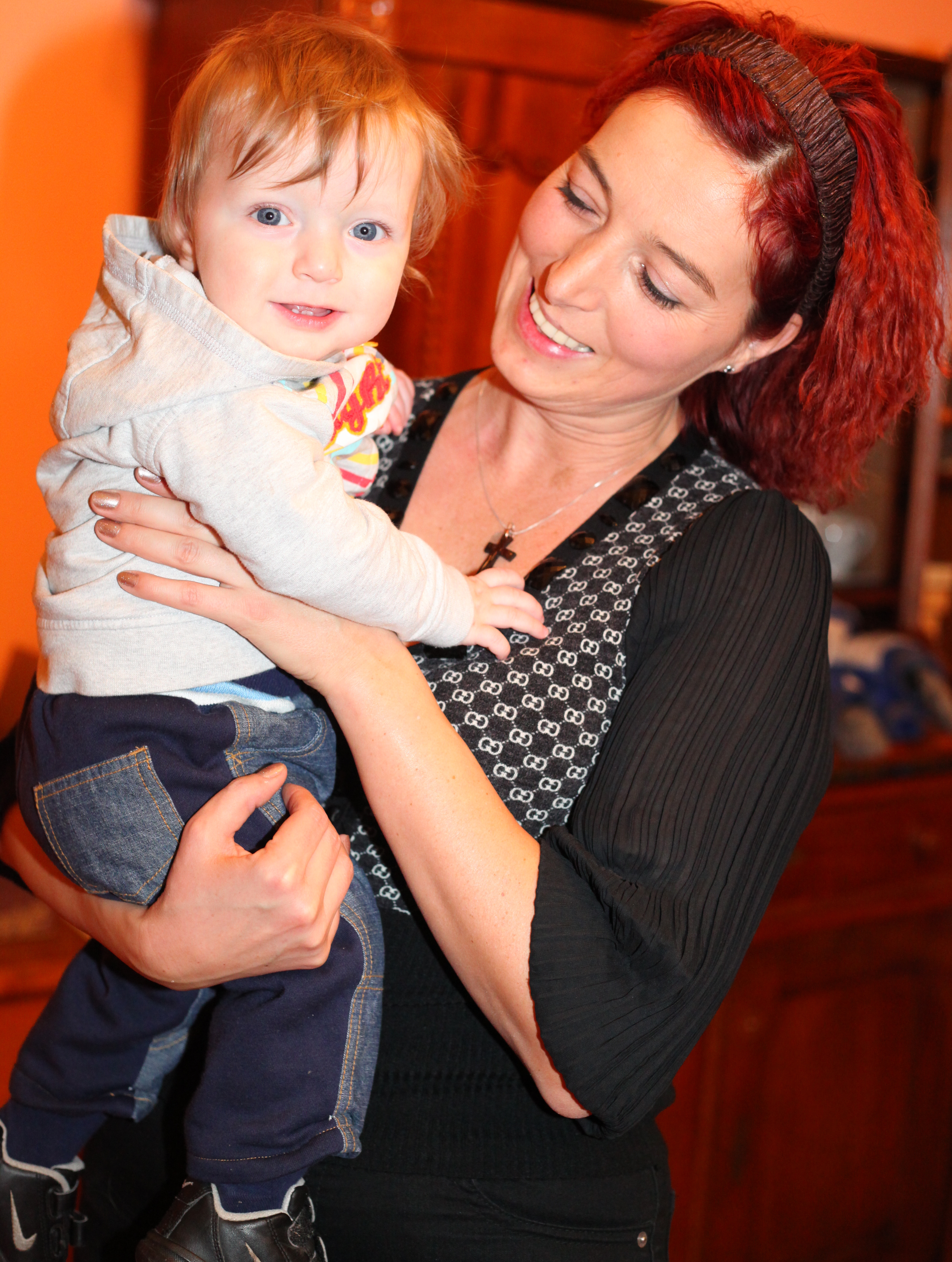 a young beautiful attractive charming Catholic woman with a baby boy, picture 1