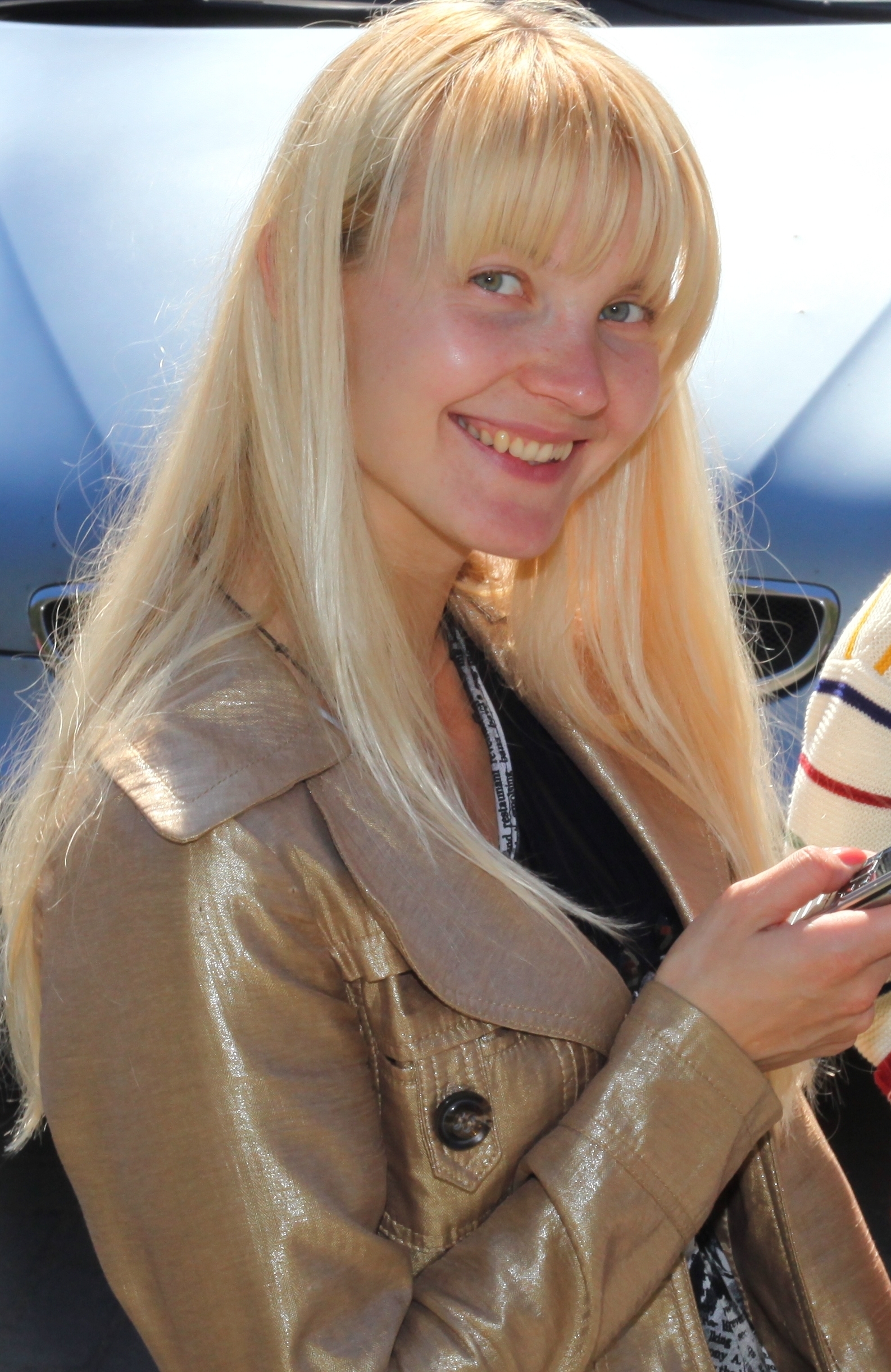 a young beautiful blond Catholic woman near a Church