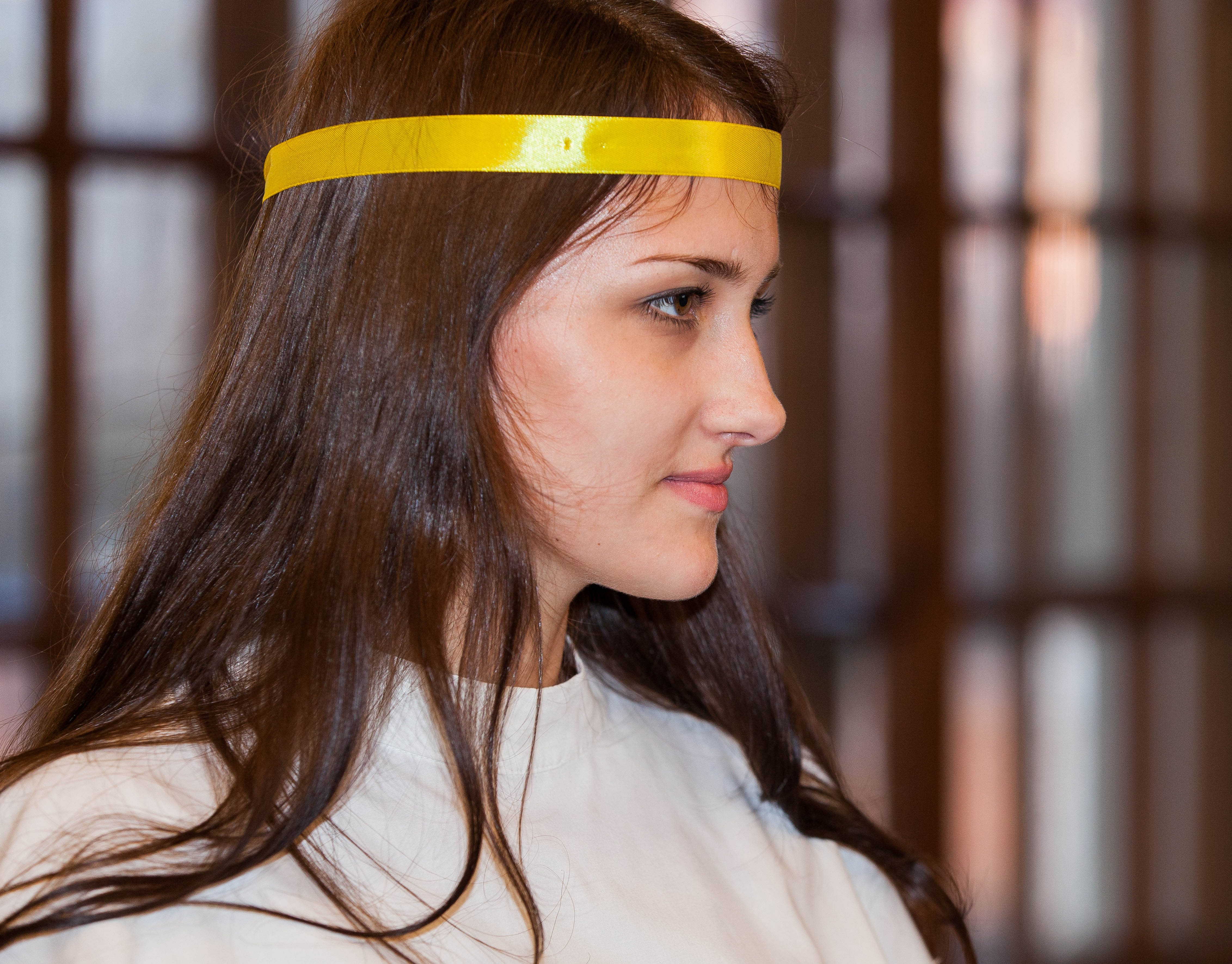 a young brunette Catholic woman in a church photographed in December 2013, picture 1